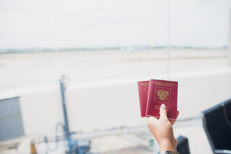 Two russian passports in hand. Russian official document on wooden backgroundの写真素材