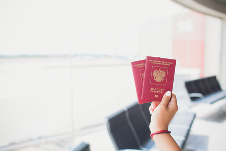 Two russian passports in hand. Russian official document on wooden backgroundの写真素材