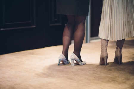 Close up fashion feet wearing contemporary beige shoes on high heels indoor. Vogue conceptの写真素材