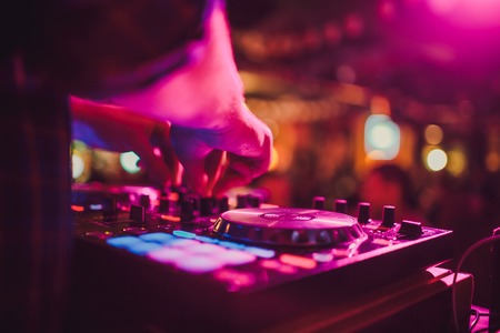 DJ remote, turntables, and hands . Night life at the club, party.の写真素材