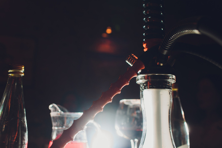 Group of black hookahs shisha on evening city background, blurred bokeh background. Modern hookah.の写真素材