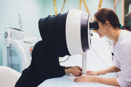 Face Skin Analyze. Cosmetologist Analyzing Woman Facial Skin.の写真素材
