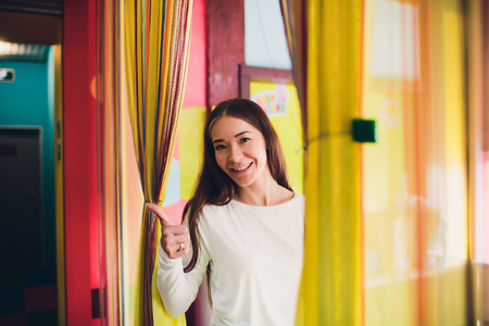 Woman, wake up and open the curtains in the morning to get fresh air.の写真素材