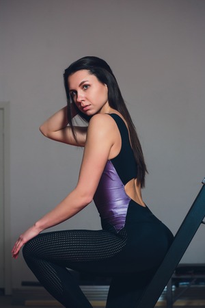 young pretty cute woman or girl with slim fit body in a gym.