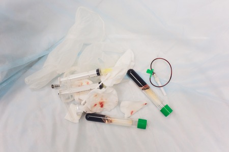 Cosmetologist desk with syringe, bottles and tourniquet used for plasma needling procedure. Vertical shot.の写真素材