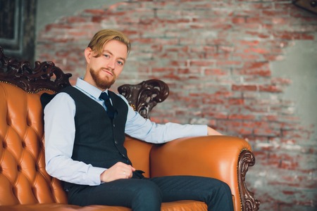 Portrait of blonde young man with uncommon appearance wears white t shirt.の写真素材