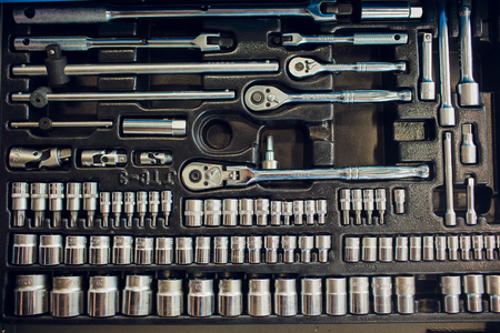 Box with special tools in car repair shop, closeup