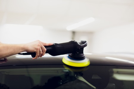 Polished black car polishing machine polished finishing. Car detailing. Selective focus