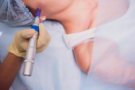 Beautician makes biorevitalization to young woman. The cosmetic procedures for the face. Beauty...