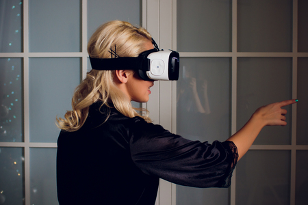 Beautiful woman wearing black Lingerie using vr-goggles.