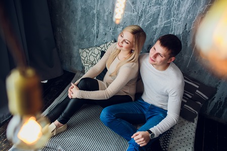 Waiting for a baby Middle-aged man sitting near pregnant wife and holding her hand