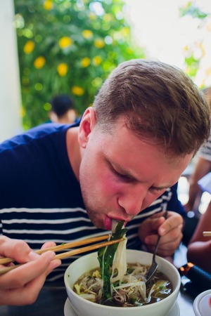 man eating soup fo in vietnam