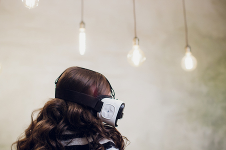 Young woman using a virtual reality headset with conceptual network lines.