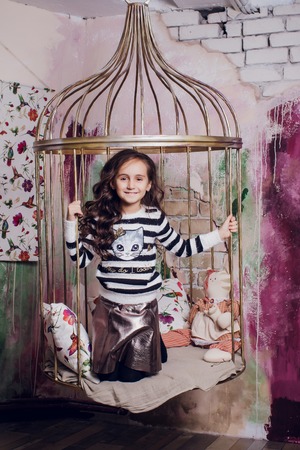 Happy little smiling girl with christmas gift box.の写真素材