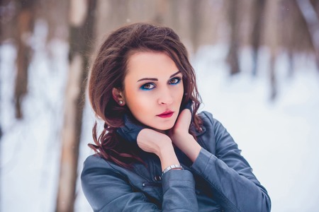 girl against the background of the winter forestの写真素材