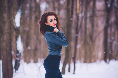 girl against the background of the winter forestの写真素材