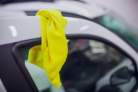 Man cleaning car door with rag, closeupの写真素材