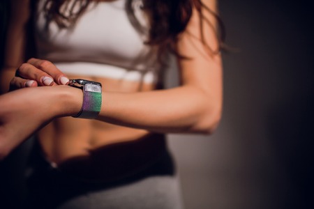 Young woman measuring heart rate after running