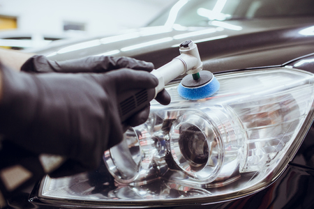 Car polish wax worker hands holding polisher and polish car detailing or valeting conceptの写真素材