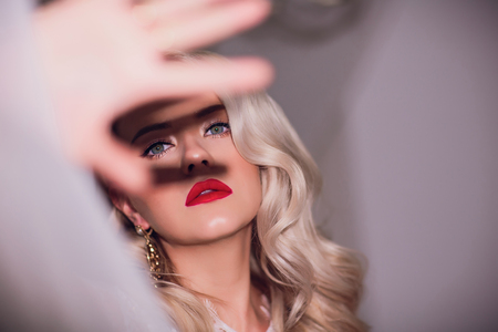 Fashion portrait Beautiful Young Woman with Blonde Hair. Girl in white Dress on White Backgroundの写真素材