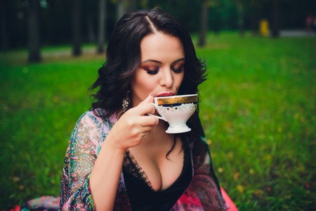 Smiling girl with mug in her hands. Girl drinking tea.の写真素材