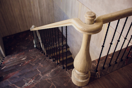 Modern curved white marble stairs with glass railing.の写真素材