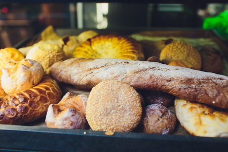 Fresh bread on shelves in a bakery.の写真素材