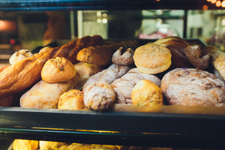 Fresh bread on shelves in a bakery.の写真素材