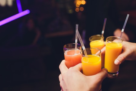 Four glasses of Italian spritz held up in a toast.の写真素材