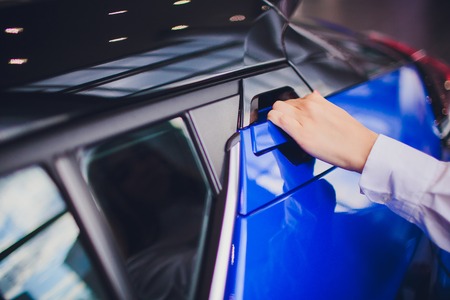 female hand for insert rear door open car. for transport and automotive imageの写真素材