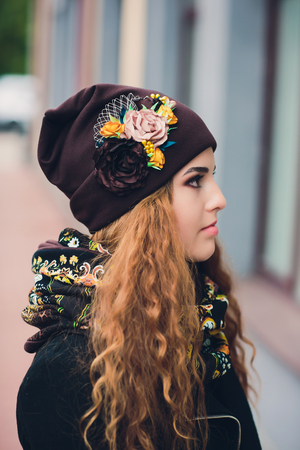 Portrait of funny young girl in the autumn weather in warm clothes and hat.の写真素材