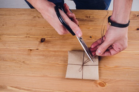 leather craftsman working making products at table in workshop studioの写真素材