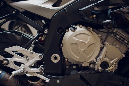 Detail on a modern and dirty motorcycle engine with oil fugues