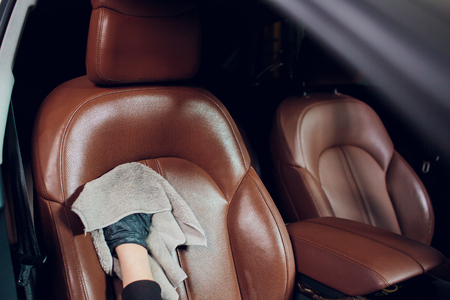 Auto service staff cleaning car interior - car detailing and valeting conceptの写真素材