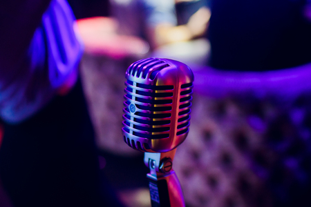 microphone on a stand up comedy stage with reflectors ray, high contrast imageの写真素材