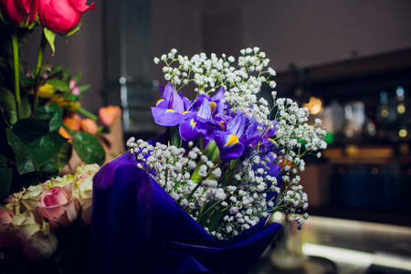 beautiful bouquet of bright flowers in basket on wooden table summerの写真素材