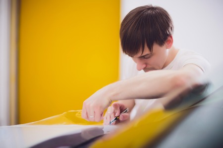 Transparent film, car paint protection, wrapping specialis. Car detailingの写真素材