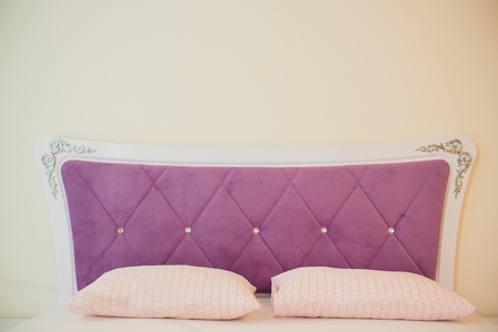 Bed maid-up with clean white pillows and bed sheets in beauty room. Close-upの写真素材