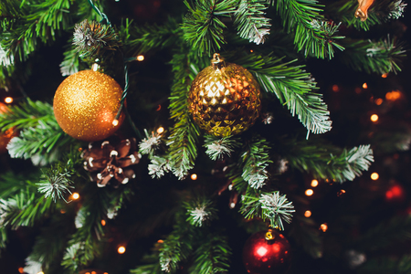 gold and silver Christmas decorations on the treeの写真素材