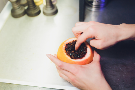 flavored hookah tobacco and fruit, a bowl of grapefruitの写真素材