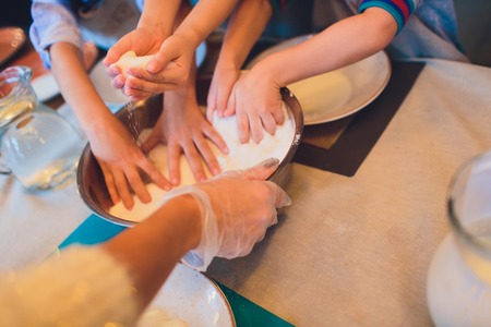 Master class for children on baking pie. Young children learn to cook a sweet pie. Kids preparing homemade pie. Little cookの写真素材
