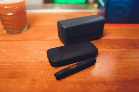 IQOS heat-not-burn tobacco product technology e-cigarette table
