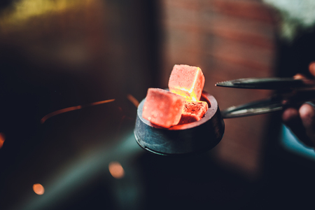 hot red coals for Shisha warmed up on the stove in a hookah bar on a dark backgroundの写真素材