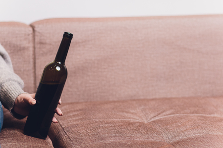 Red wine spilled on a brown couch sofa dark bottle of red wine droppedの写真素材