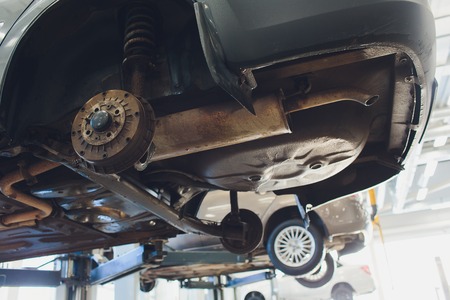 Car raised on car lift in autoservice