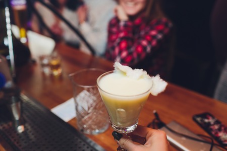 Closeup glass of Iced Bubble gum with soda and topped with cotton candy, served with whipped cream - Summer Cocktail or Tropical Mocktail, Selective focusの写真素材
