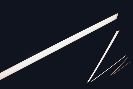 Silver and copper metal curved ribbon chandelier closeup. Modern metal lampshade. Black and white abstract textured background. Abstract chaotic pattern. Futuristic backdrop. Interior decorationの写真素材