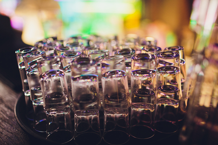 Empty shot glasses waiting on the counter for the party to start.の写真素材