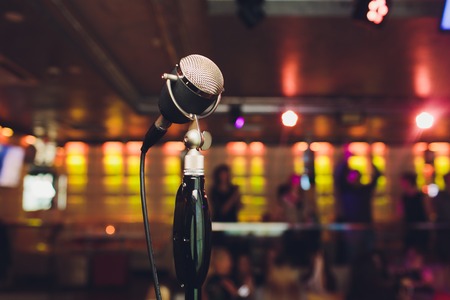 Microphone. Retro microphone. A microphone on stage. A pub. Bar. Restaurant. Classic. Evening. Night show. European restaurant European bar American restaurant American barの写真素材