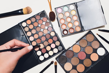 Makeup brushes and make-up eye shadows on a white backgroundの写真素材